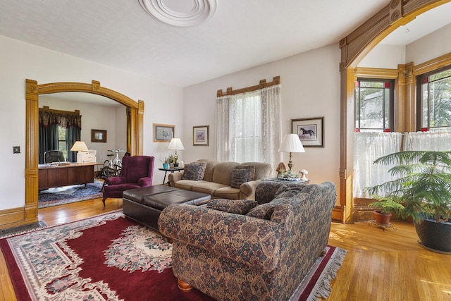 466 Quail Trap Rd, Caledonia, IL 61011 - living area featuring wood finished floors, a desk, and arched walkways