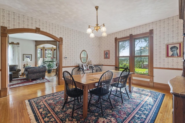 466 Quail Trap Rd, Caledonia, IL 61011 - dining space featuring a wainscoted wall, light wood-type flooring, a chandelier, and wallpapered walls