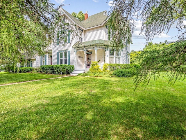 466 Quail Trap Rd, Caledonia, IL 61011 - victorian house featuring a porch, a front lawn, and a chimney
