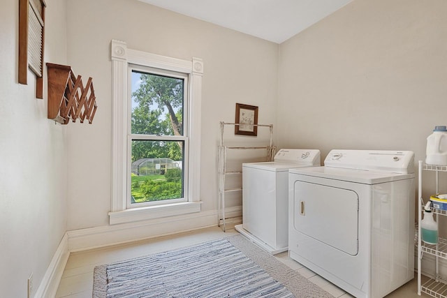 466 Quail Trap Rd, Caledonia, IL 61011 - washroom with washing machine and dryer, healthy amount of natural light, and light tile patterned floors