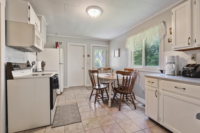 466 Quail Trap Rd, Caledonia, IL 61011 - kitchen featuring stove, crown molding, backsplash, and white cabinets