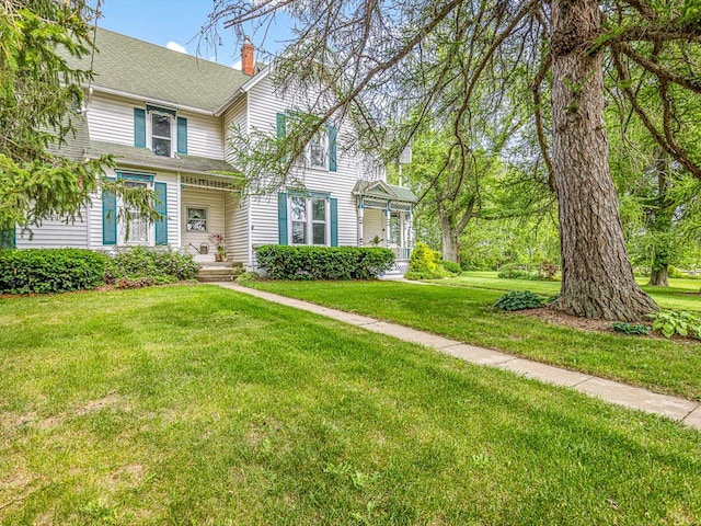 466 Quail Trap Rd, Caledonia, IL 61011 - view of front of property featuring a chimney and a front lawn