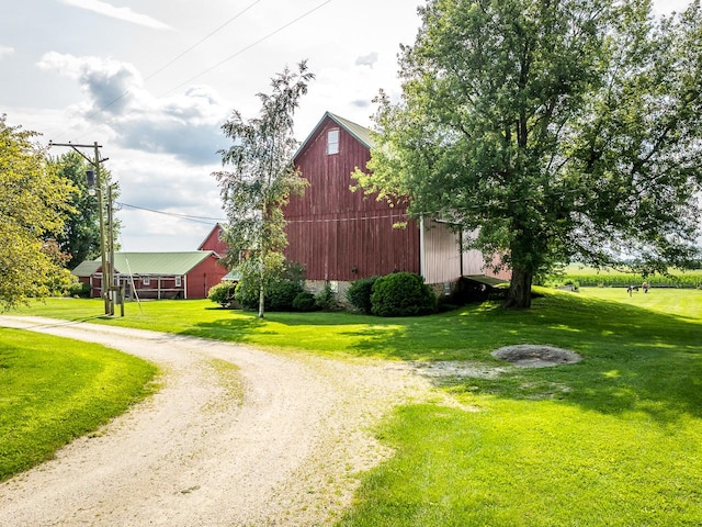 466 Quail Trap Rd, Caledonia, IL 61011 - view of barn with a yard and driveway