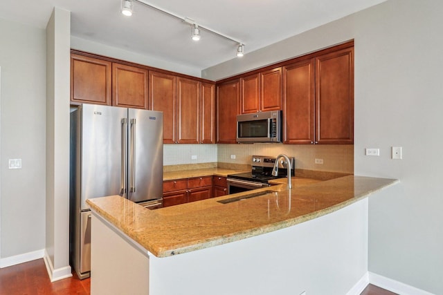 1841 S Calumet Ave Unit 1302, Chicago, IL 60616 - kitchen with stainless steel appliances, a peninsula, light stone counters, and brown cabinets
