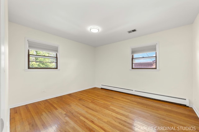 140 W Adams St, Villa Park, IL 60181 - empty room featuring a baseboard heating unit and light wood-style flooring