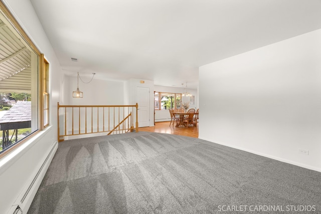 140 W Adams St, Villa Park, IL 60181 - carpeted empty room featuring a baseboard radiator, a chandelier, and a baseboard heating unit