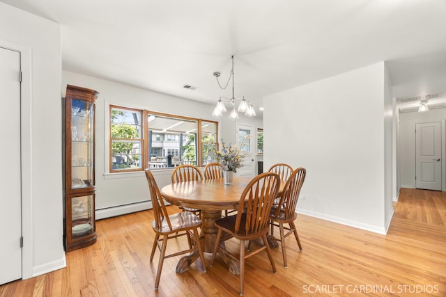 140 W Adams St, Villa Park, IL 60181 - dining space featuring a baseboard heating unit, light wood-type flooring, and a chandelier