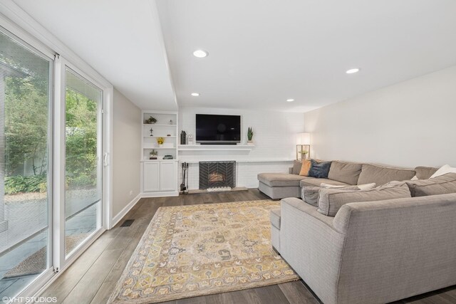 1407 N Dunton Ave, Arlington Heights, IL 60004 - living room featuring dark wood finished floors, recessed lighting, and a lit fireplace