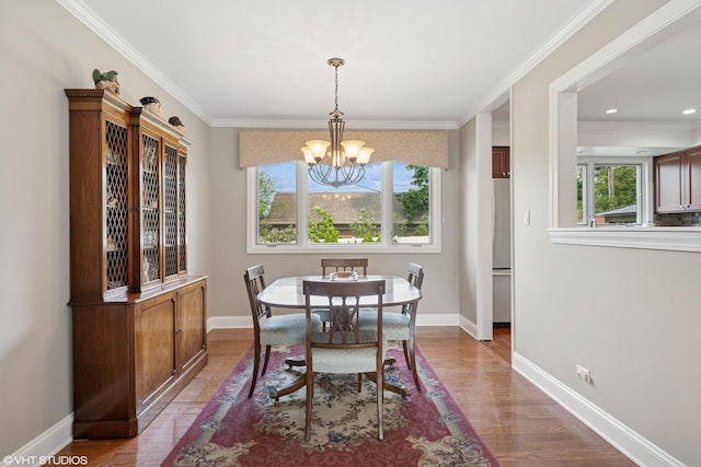 1407 N Dunton Ave, Arlington Heights, IL 60004 - dining space featuring a chandelier, healthy amount of natural light, wood finished floors, and crown molding