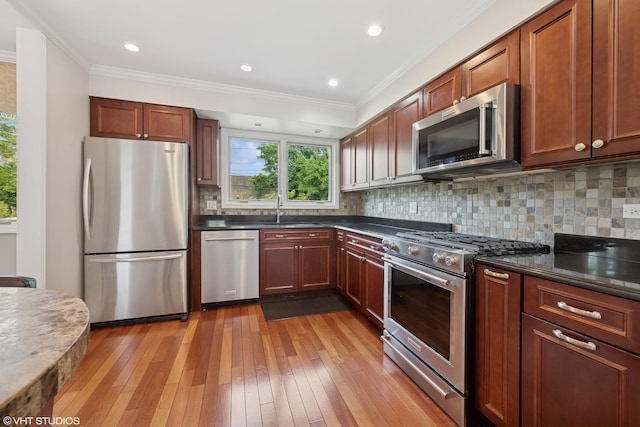 1407 N Dunton Ave, Arlington Heights, IL 60004 - kitchen with stainless steel appliances, light wood-style floors, ornamental molding, decorative backsplash, and recessed lighting