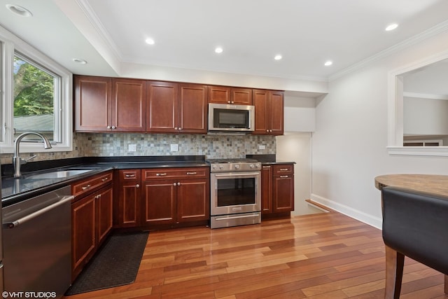 1407 N Dunton Ave, Arlington Heights, IL 60004 - kitchen with appliances with stainless steel finishes, light wood-type flooring, backsplash, ornamental molding, and recessed lighting