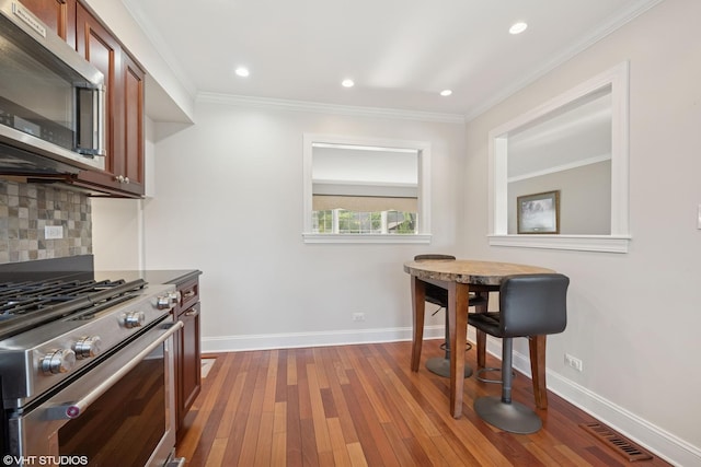 1407 N Dunton Ave, Arlington Heights, IL 60004 - kitchen with stainless steel appliances, backsplash, hardwood / wood-style flooring, crown molding, and recessed lighting