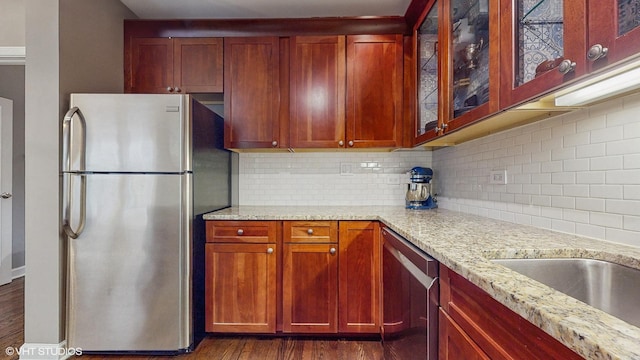 4550 N Malden St Unit 1W, Chicago, IL 60640 - kitchen with appliances with stainless steel finishes, dark wood finished floors, light stone countertops, tasteful backsplash, and glass insert cabinets
