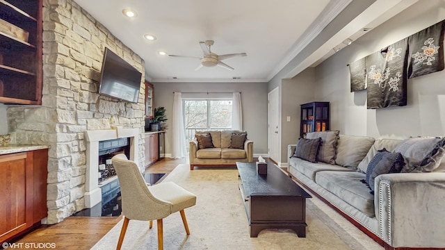 4550 N Malden St Unit 1W, Chicago, IL 60640 - living room featuring ornamental molding, ceiling fan, light wood-style floors, recessed lighting, and a stone fireplace