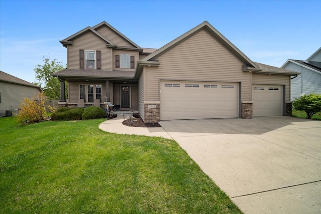 2321 Corrigan Way, Normal, IL 61761 - view of front of property with a garage, concrete driveway, covered porch, a front lawn, and brick siding