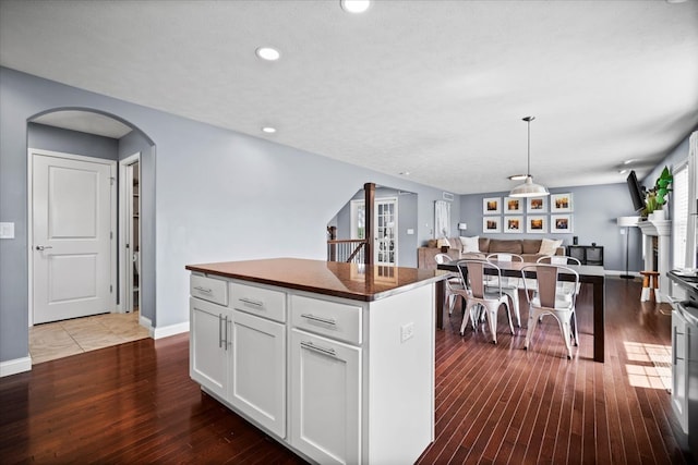 2321 Corrigan Way, Normal, IL 61761 - kitchen with open floor plan, arched walkways, dark countertops, dark wood-style floors, and recessed lighting
