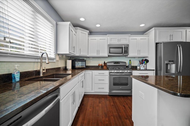 2321 Corrigan Way, Normal, IL 61761 - kitchen with stainless steel appliances, white cabinetry, dark stone countertops, recessed lighting, and dark wood finished floors