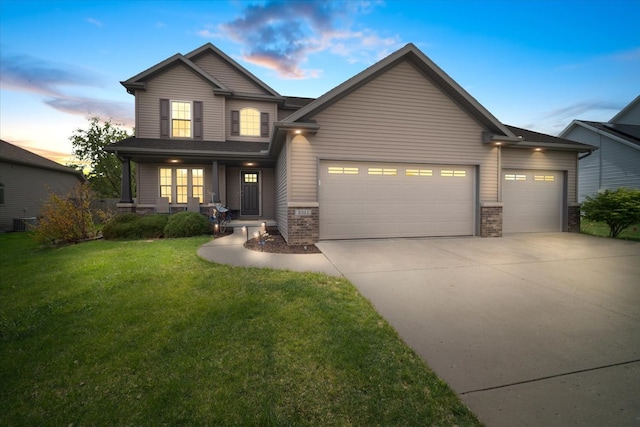 2321 Corrigan Way, Normal, IL 61761 - view of front facade featuring a garage, brick siding, driveway, and a yard