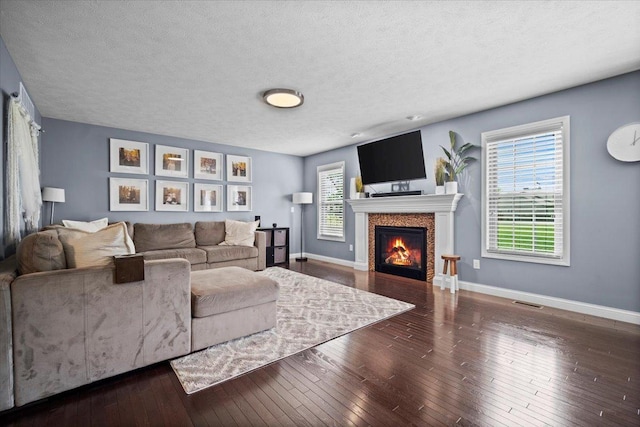 2321 Corrigan Way, Normal, IL 61761 - living room with hardwood / wood-style flooring, a textured ceiling, and a lit fireplace
