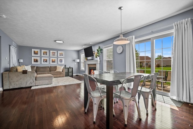 2321 Corrigan Way, Normal, IL 61761 - dining space featuring a warm lit fireplace and dark wood-type flooring