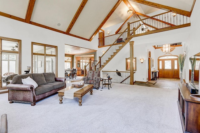 42720 N Converse Rd, Antioch, IL 60002 - carpeted living room with high vaulted ceiling, stairs, beam ceiling, and a chandelier