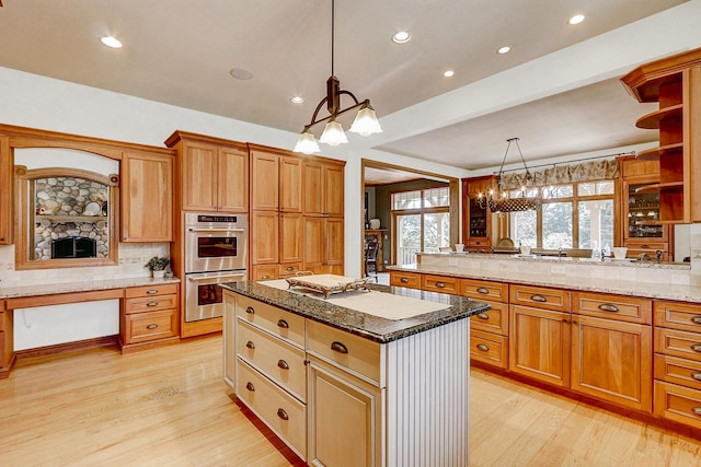 42720 N Converse Rd, Antioch, IL 60002 - kitchen with double oven, a chandelier, light wood-type flooring, backsplash, and a center island