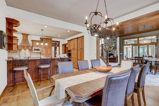 42720 N Converse Rd, Antioch, IL 60002 - dining room with a chandelier, light wood-type flooring, recessed lighting, and a stone fireplace