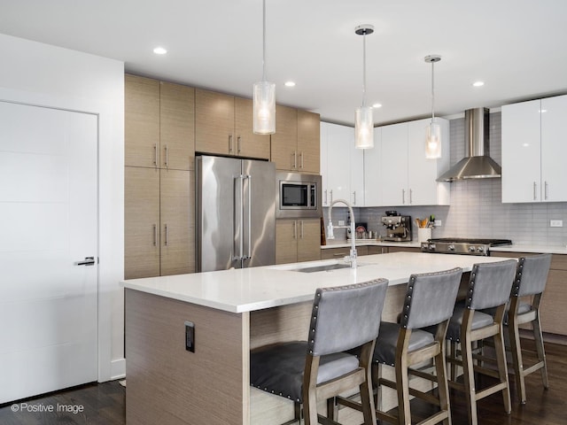 2707 W Belmont Ave Unit 4W, Chicago, IL 60618 - kitchen featuring stainless steel appliances, wall chimney range hood, a breakfast bar area, decorative backsplash, and recessed lighting