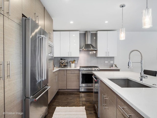 2707 W Belmont Ave Unit 4W, Chicago, IL 60618 - kitchen with wall chimney range hood, high quality appliances, modern cabinets, dark wood finished floors, and pendant lighting