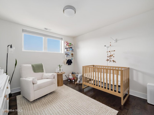 2707 W Belmont Ave Unit 4W, Chicago, IL 60618 - bedroom featuring a crib and wood finished floors
