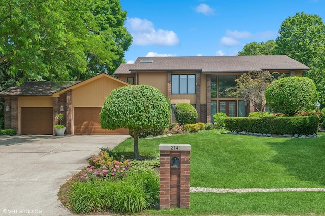 2741 Acacia Ter, Buffalo Grove, IL 60089 - mid-century inspired home with a front yard, driveway, an attached garage, brick siding, and a shingled roof