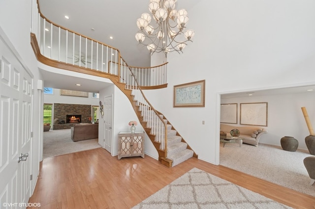 2741 Acacia Ter, Buffalo Grove, IL 60089 - carpeted foyer entrance featuring a towering ceiling, stairway, wood finished floors, a fireplace, and recessed lighting