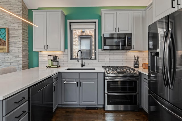 3047 N Racine Ave Unit 3, Chicago, IL 60657 - kitchen featuring stainless steel appliances, gray cabinets, backsplash, dark wood finished floors, and white cabinetry