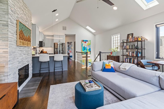 3047 N Racine Ave Unit 3, Chicago, IL 60657 - living area with a skylight, plenty of natural light, dark wood-style floors, a fireplace, and high vaulted ceiling