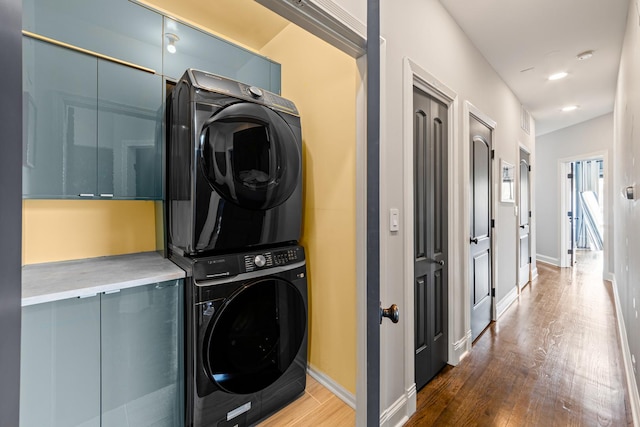 3047 N Racine Ave Unit 3, Chicago, IL 60657 - laundry area featuring stacked washing machine and dryer and wood finished floors