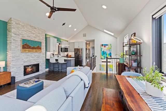 3047 N Racine Ave Unit 3, Chicago, IL 60657 - living area with ceiling fan, dark wood-style floors, a stone fireplace, high vaulted ceiling, and recessed lighting