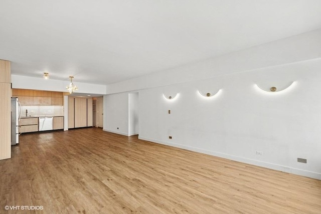 175 E Delaware Pl Unit 6021, Chicago, IL 60611 - unfurnished living room featuring wood finished floors and a chandelier