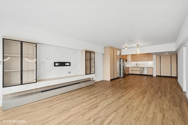 175 E Delaware Pl Unit 6021, Chicago, IL 60611 - unfurnished living room featuring wood finished floors and a sink