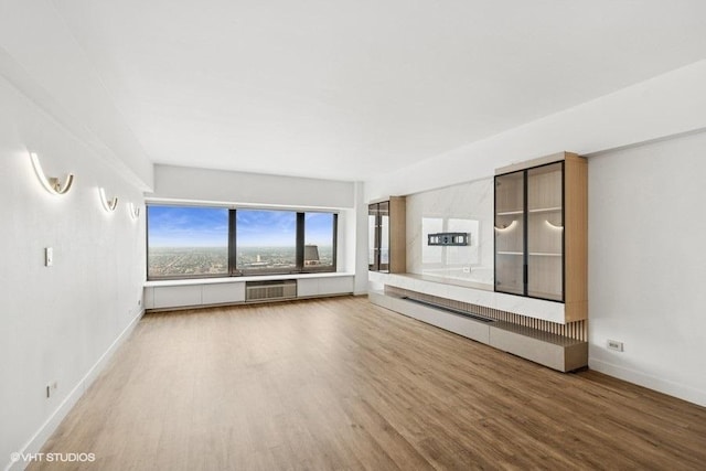 175 E Delaware Pl Unit 6021, Chicago, IL 60611 - unfurnished living room featuring wood finished floors and a wall unit AC