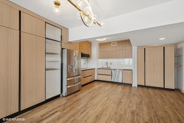 175 E Delaware Pl Unit 6021, Chicago, IL 60611 - kitchen with appliances with stainless steel finishes, light wood-type flooring, light countertops, a chandelier, and light brown cabinets