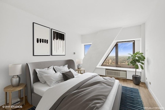 175 E Delaware Pl Unit 6021, Chicago, IL 60611 - bedroom featuring an AC wall unit and wood finished floors