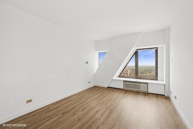 175 E Delaware Pl Unit 6021, Chicago, IL 60611 - additional living space with wood finished floors and a wall mounted air conditioner