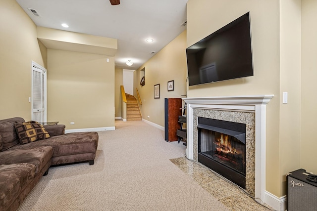 4660 N Winthrop Ave Unit 1N, Chicago, IL 60640 - carpeted living area featuring stairs, a tiled fireplace, and recessed lighting