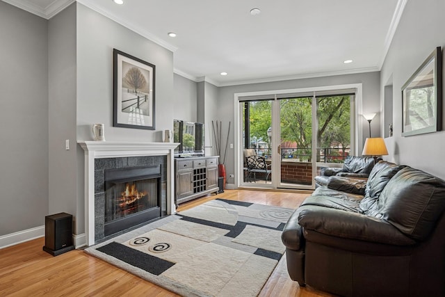4660 N Winthrop Ave Unit 1N, Chicago, IL 60640 - living area with light wood-style floors, recessed lighting, a tiled fireplace, and ornamental molding