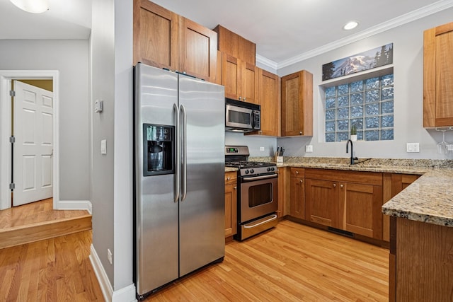 4660 N Winthrop Ave Unit 1N, Chicago, IL 60640 - kitchen featuring stainless steel appliances, light wood-style flooring, light stone counters, brown cabinetry, and ornamental molding