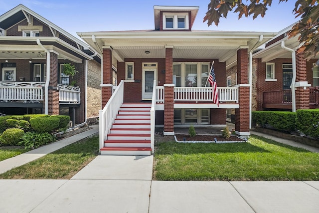 2219 S 60th Ct, Cicero, IL 60804 - view of front of home featuring covered porch, brick siding, and a front yard