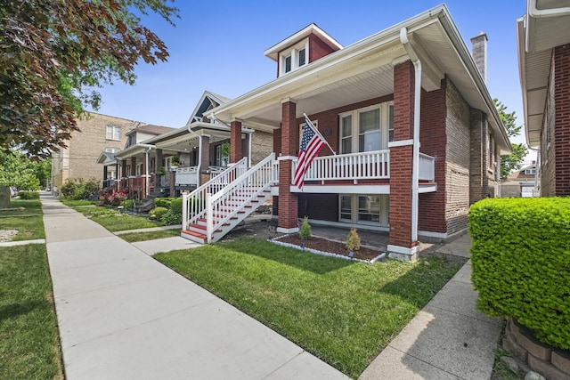 2219 S 60th Ct, Cicero, IL 60804 - bungalow-style house with brick siding, a porch, and a front yard