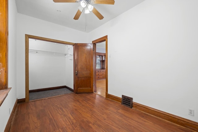 2219 S 60th Ct, Cicero, IL 60804 - unfurnished bedroom with dark wood-style floors, a closet, and ceiling fan