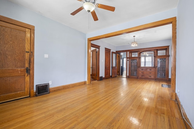 2219 S 60th Ct, Cicero, IL 60804 - unfurnished living room with light wood-style flooring, ceiling fan, and a chandelier