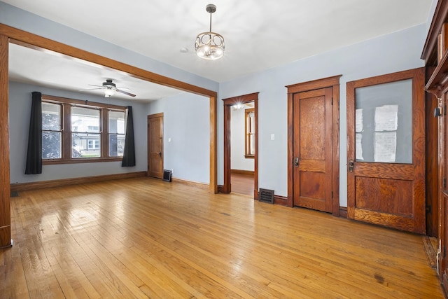 2219 S 60th Ct, Cicero, IL 60804 - unfurnished room featuring light wood-style floors, a chandelier, and ceiling fan